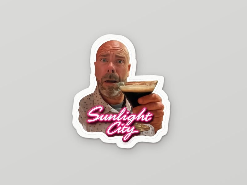 Die-cut sticker: a bald, bearded guy raising an espresso martini over pink Sunlight City script